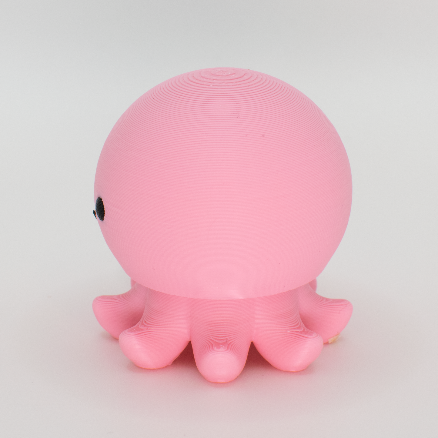 side view of a pink octopus mechanical switch fidget toy 