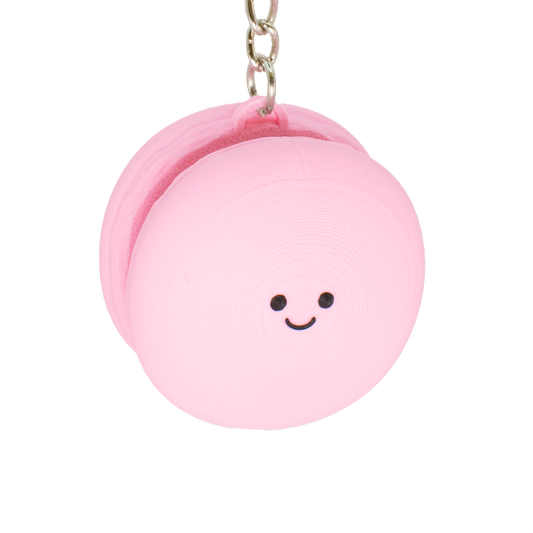 Cute macaron fidget clicker keychain with a smiling face