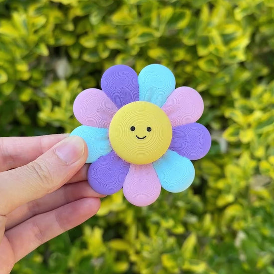 Clicking and spinning the cute, colourful flower fidget for calming sensory play