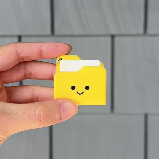 Pressing the cute yellow folder fidget clicker for a satisfying click