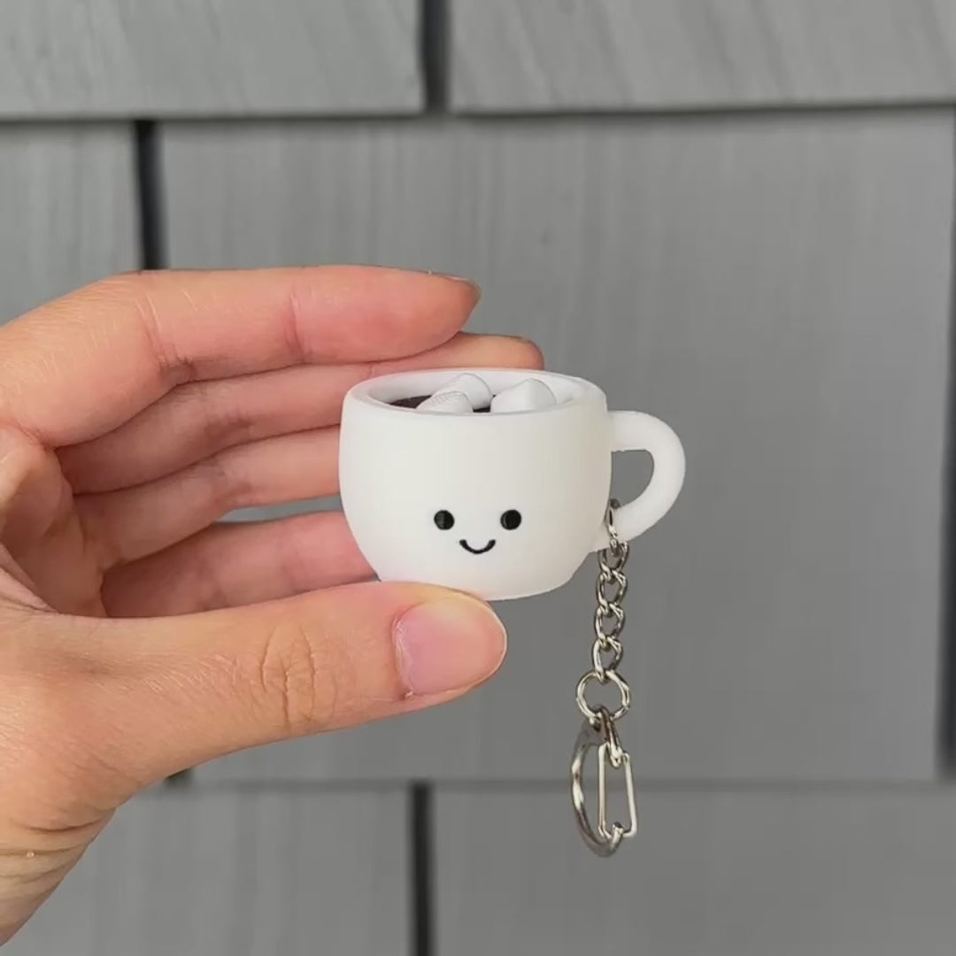 hand clicking a cute hot chocolate fidget clicker with a satisfying sound