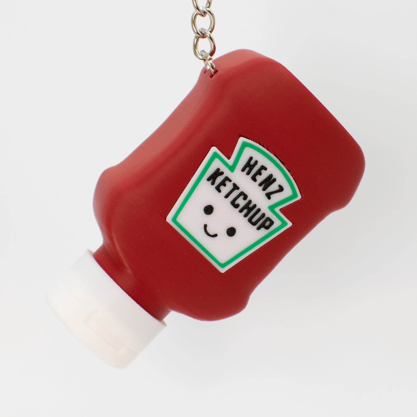 Red ketchup bottle fidget toy keychain with a cute smiling face