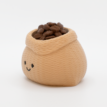 side view of a fidget clicker styled as a chubby textured beige sack with a smiley face filled with coffee beans 