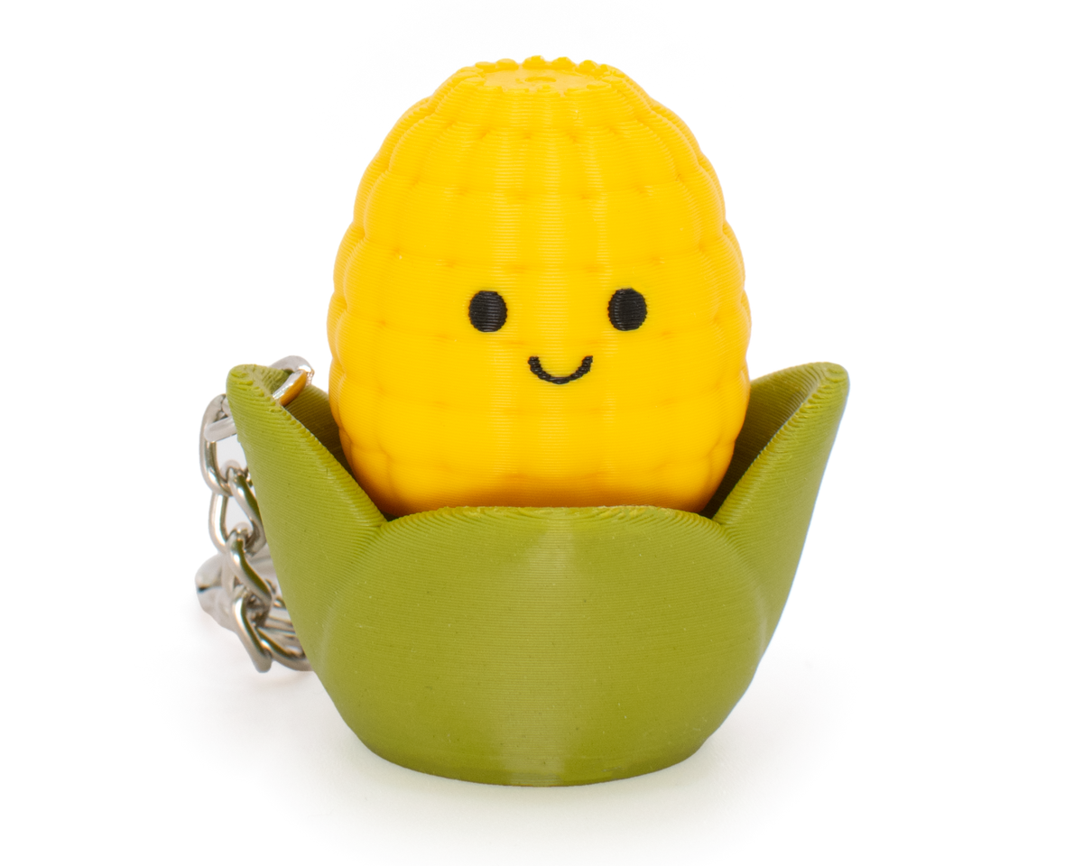 fidget clicker styled as a cute yellow and green corn with smiley face