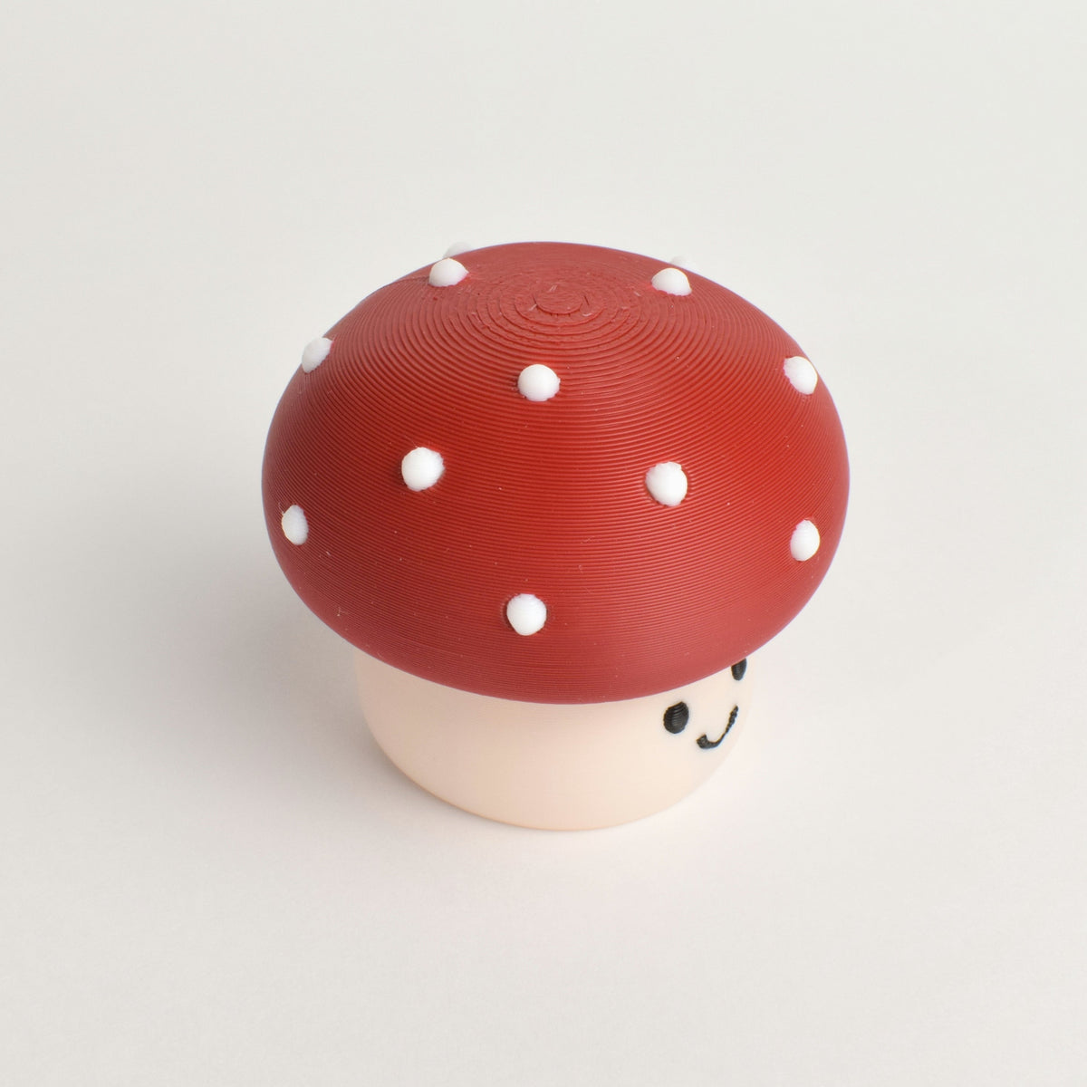 Top view of a mushroom clicker showing the round cap and white dots