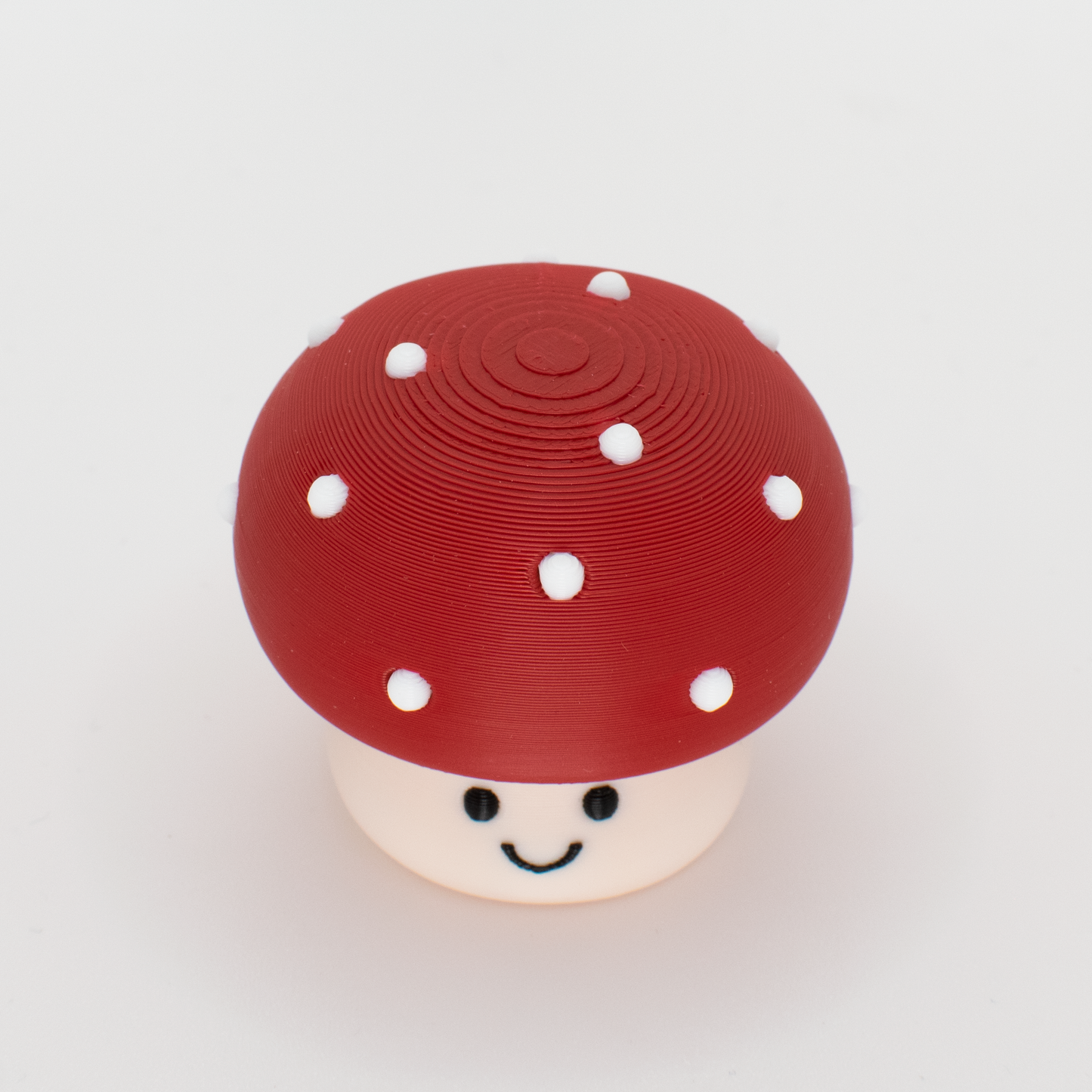 Top view of a mushroom clicker showing the round cap and white dots