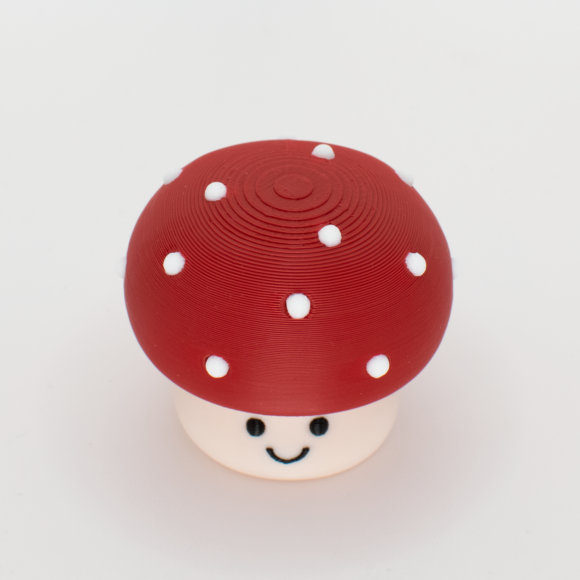 Top view of a mushroom clicker showing the round cap and white dots