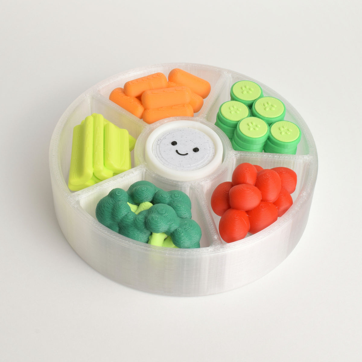 A colorful veggie platter clicker fidget toy with multiple switches (6) and a smiley face on a white background. There are carrots, cucumbers, cherry tomatoes, celery, broccoli, and a dipping sauce.